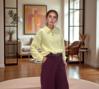 Woman wearing bordeaux wide-leg trousers and pastel sweater in modern living room, Josephine style