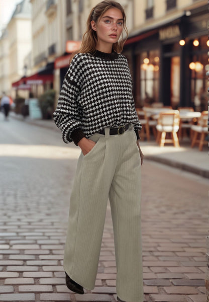 Woman wearing light beige corduroy pants and black houndstooth sweater on city street, Josephine