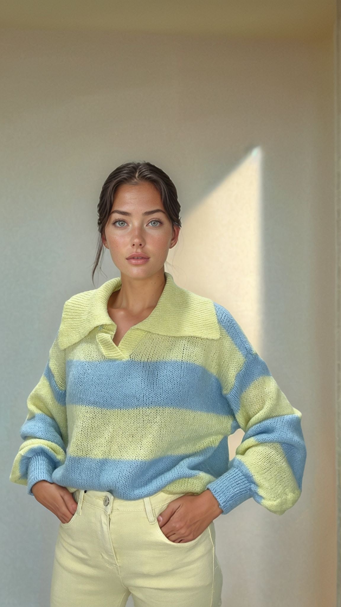 Woman modeling Josephine yellow and blue striped knit sweater with wide collar and cream pants